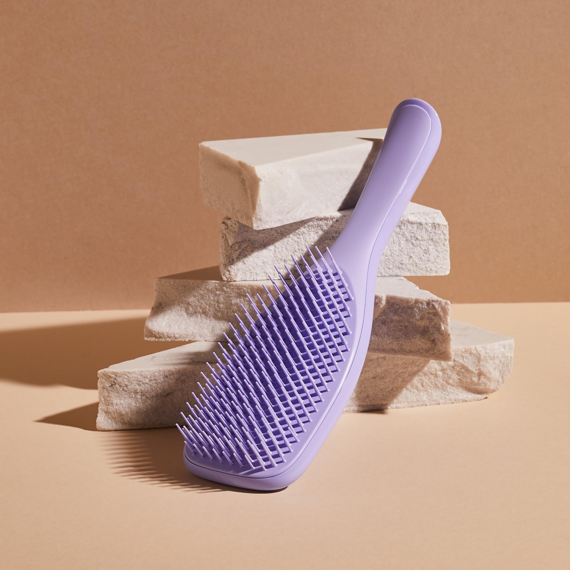 Tangle Teezer Ultimate Detangler Brush in shower use distributes conditioner evenly for smooth brushing.