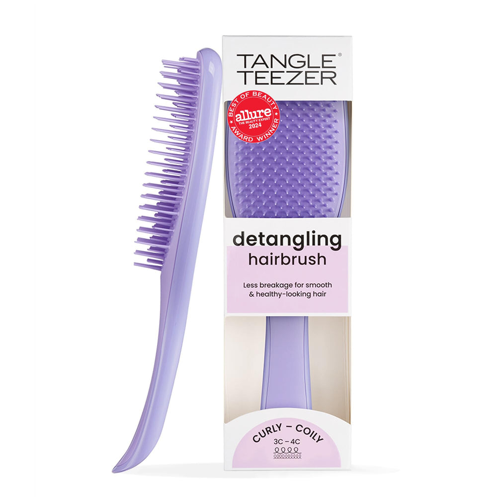 Tangle Teezer Ultimate Detangler close-up showing firm-flex teeth detangling thick curls