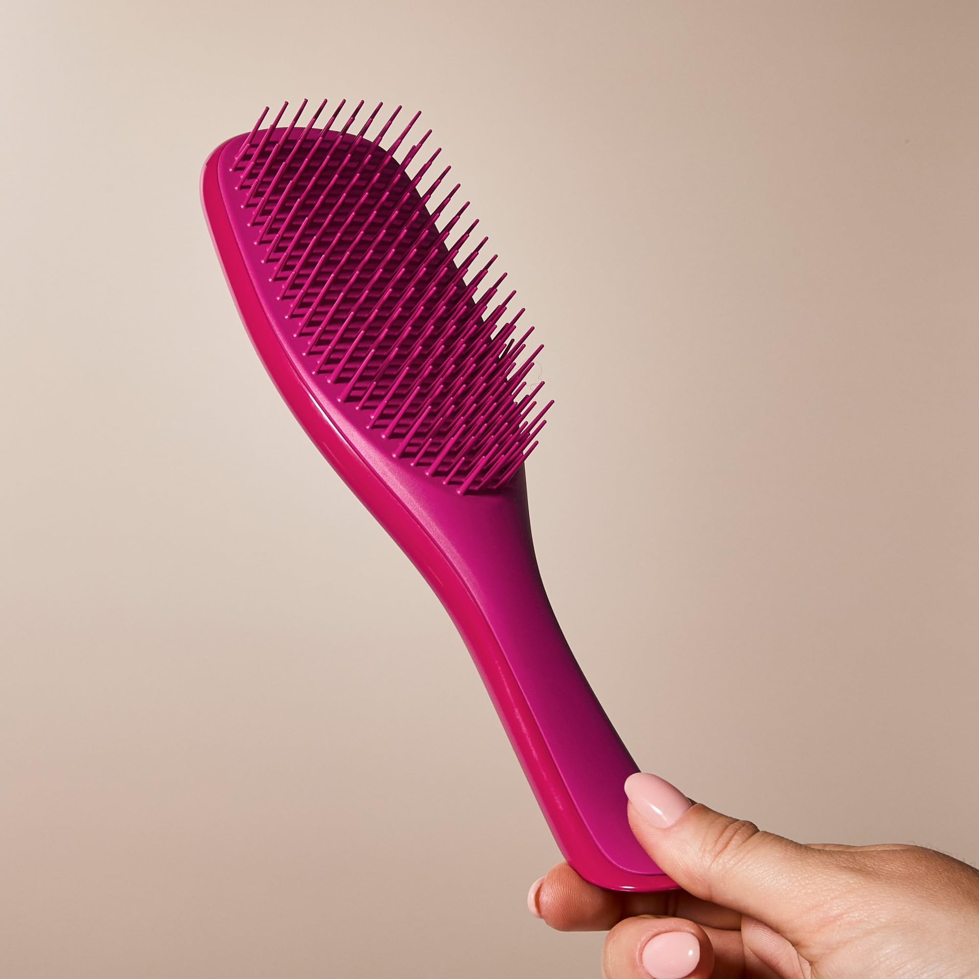 Ergonomic handle of the Ultimate Detangler for comfortable detangling sessions.