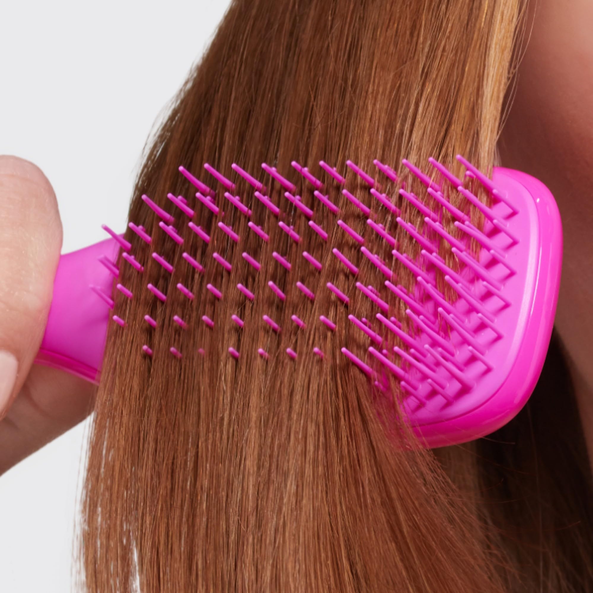 Brush in a compact case suitable for gym bag storage.