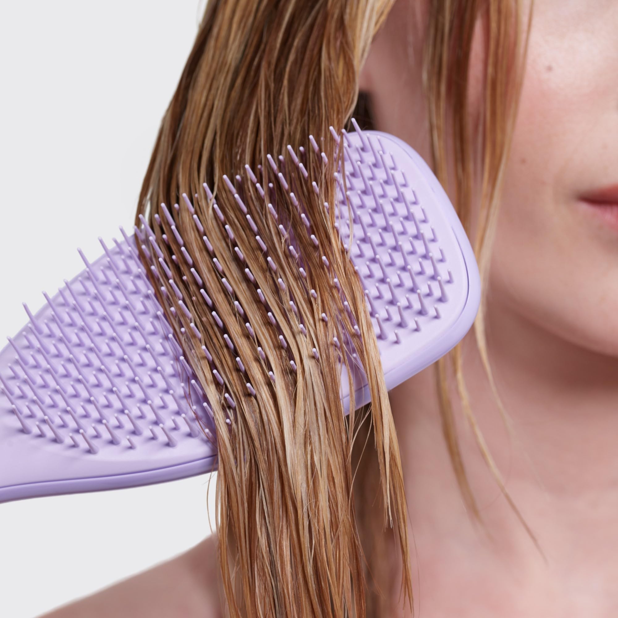 Tangle Teezer Hypnotic Heather hair-care routine shot suggests silky-smooth results.