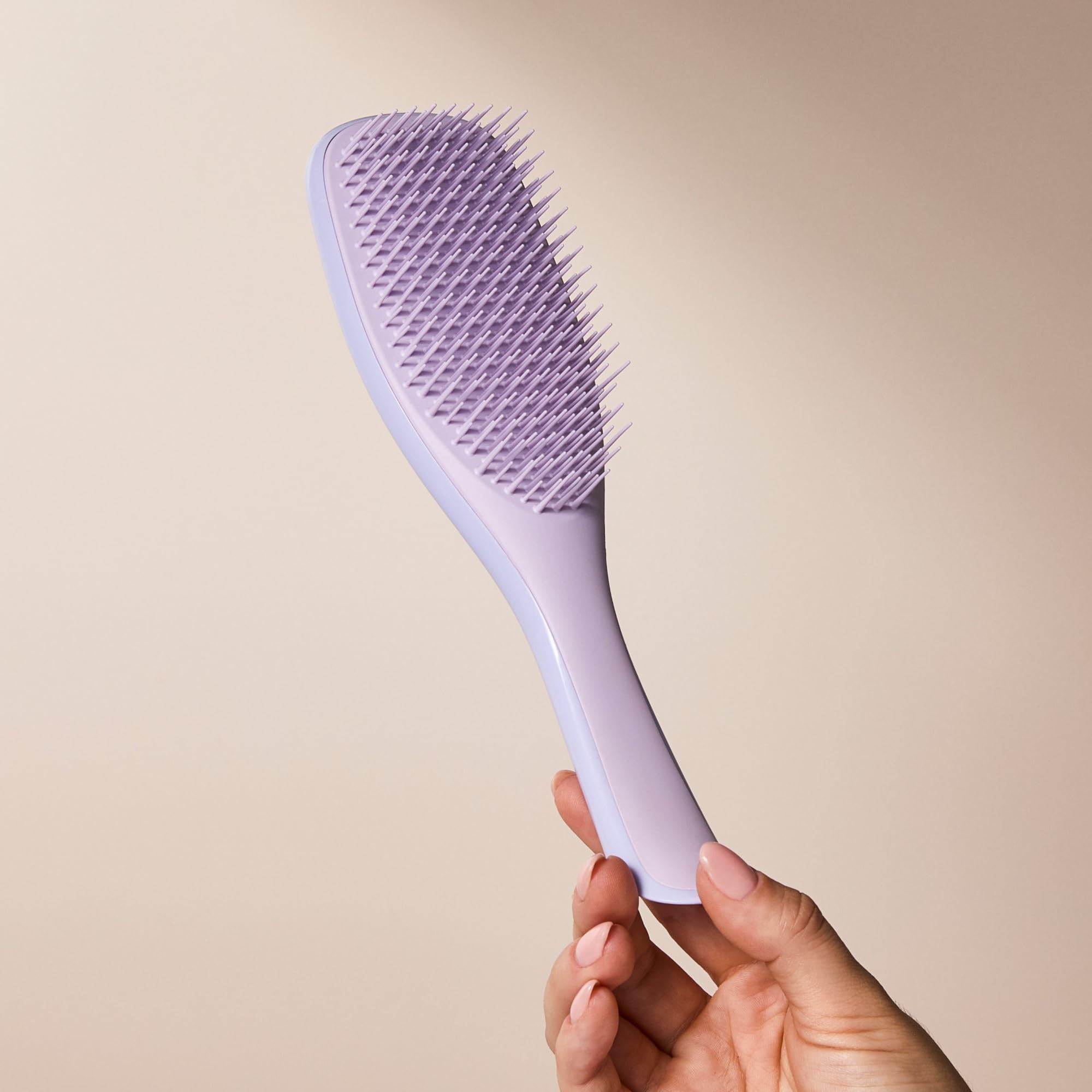Tangle Teezer Hypnotic Heather product-use shot shows even conditioner distribution.