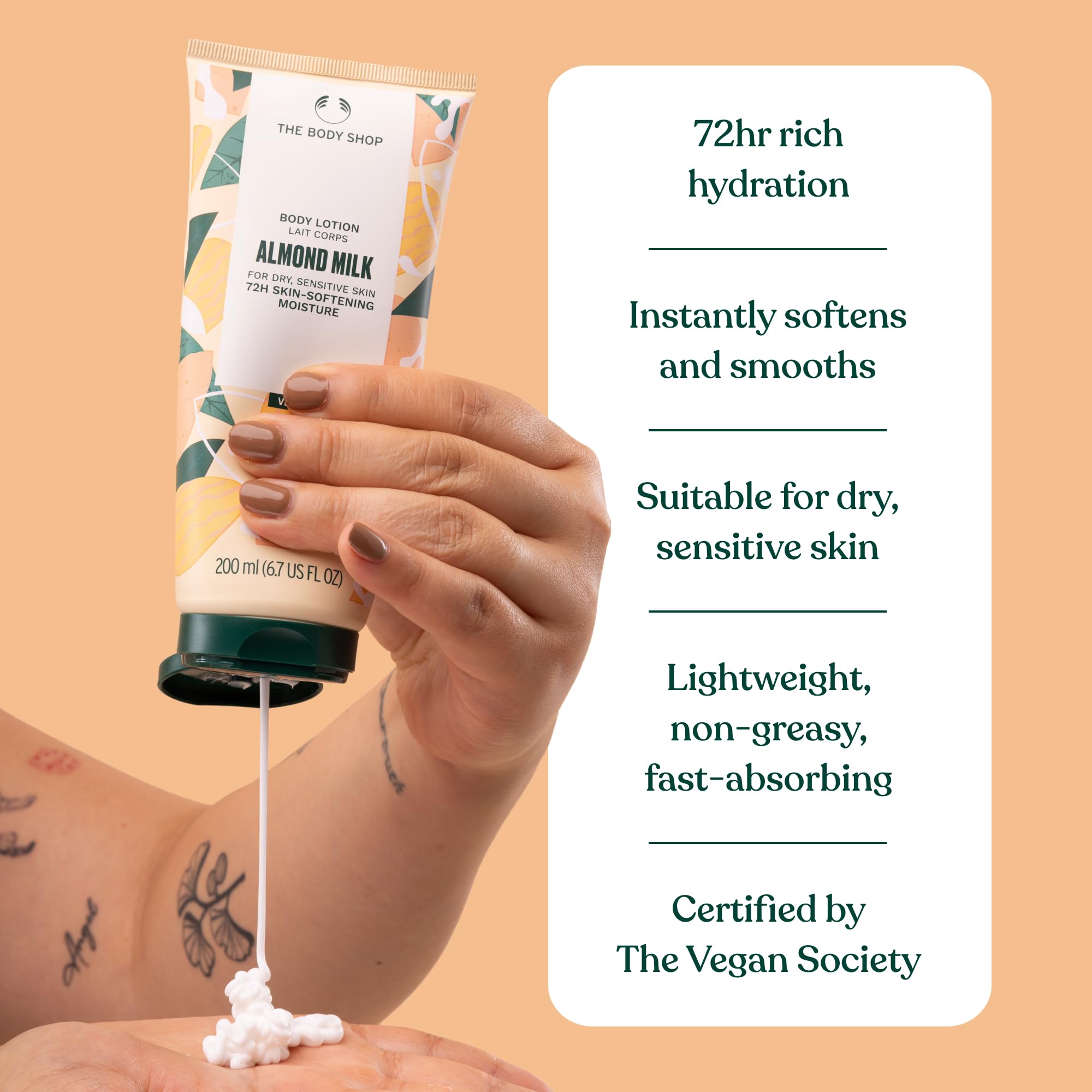 The Body Shop Almond Milk and Honey lotion on bathroom shelf with natural glow.