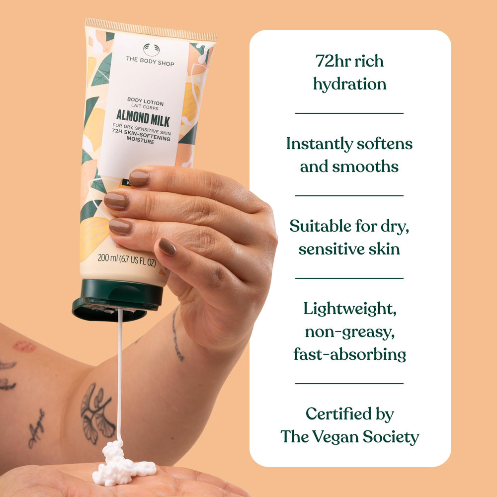 The Body Shop Almond Milk and Honey lotion on bathroom shelf with natural glow.