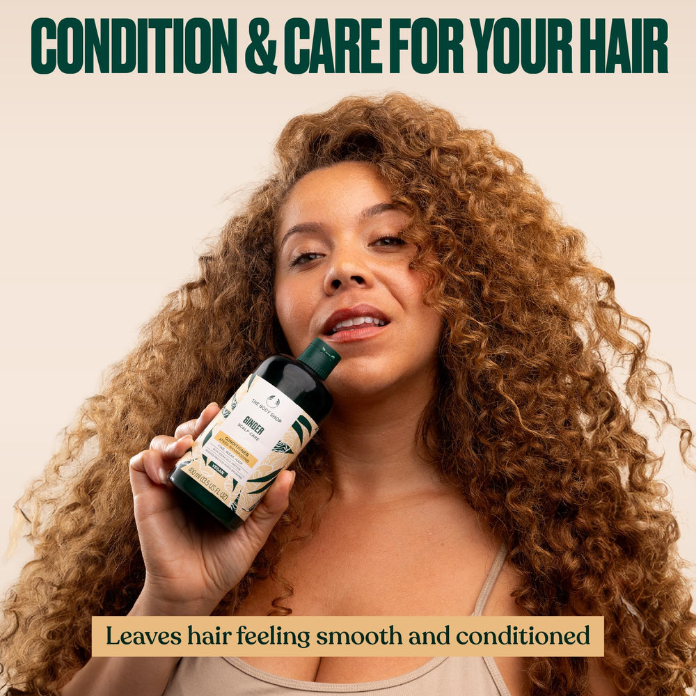 The Body Shop Ginger Scalp Care Conditioner applied to hair for stronger-feeling strands.