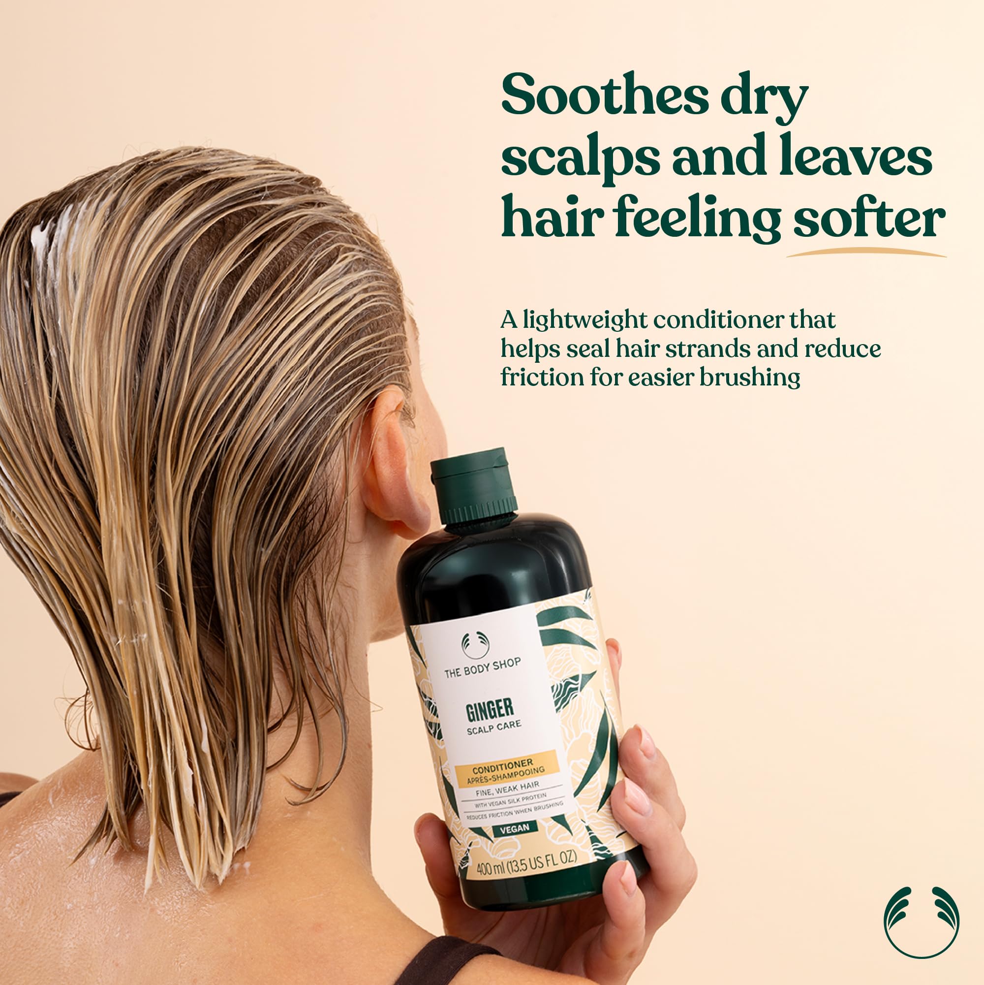 The Body Shop Ginger Scalp Care Conditioner pump close-up demonstrates easy application for hydrated hair.