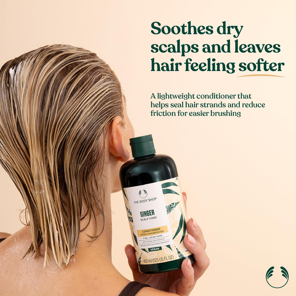 The Body Shop Ginger Scalp Care Conditioner pump close-up demonstrates easy application for hydrated hair.