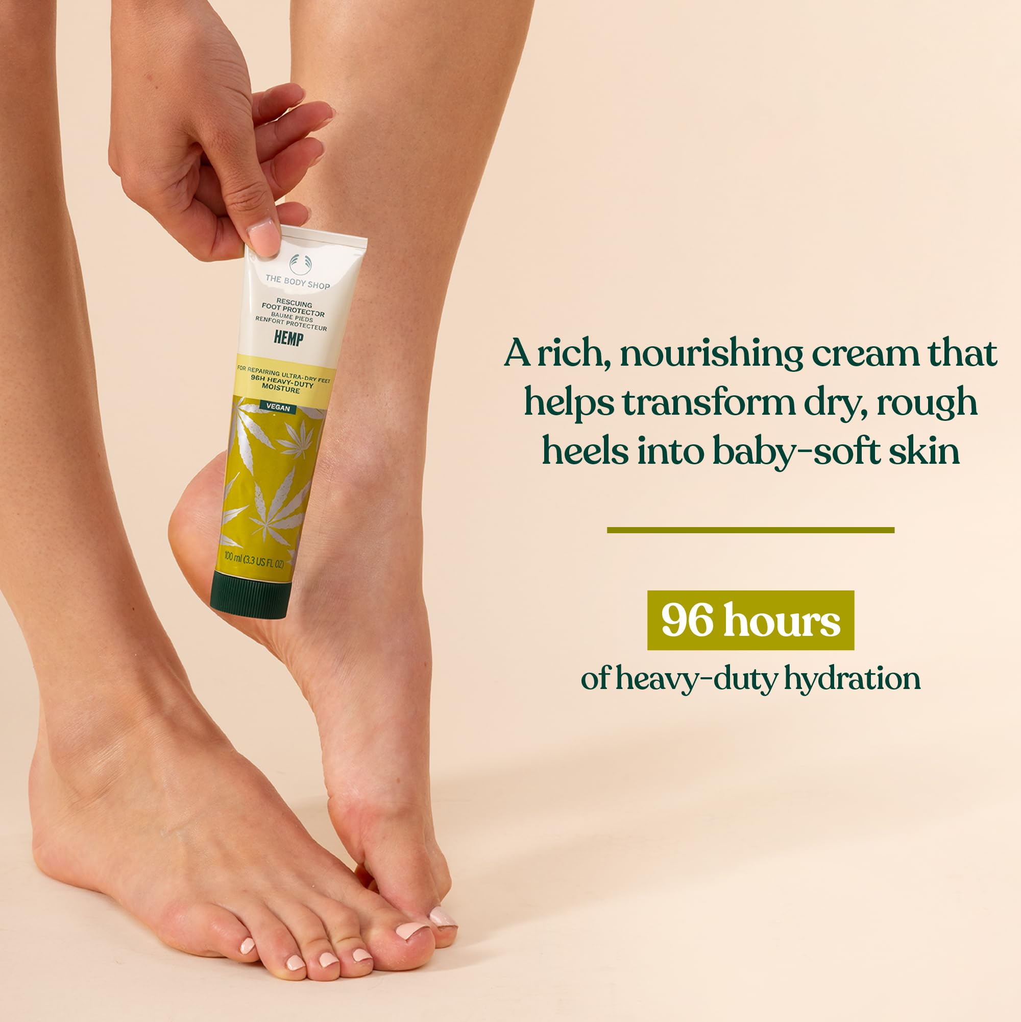 The Body Shop Hemp Foot Protector tube on surface highlights 24-hour hydration promise