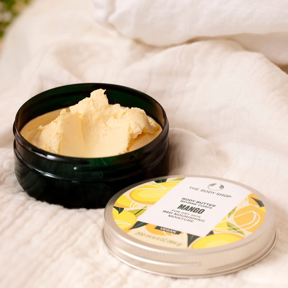 The Body Shop Mango Body Butter texture swirl emphasizes rich, non-greasy hydration.