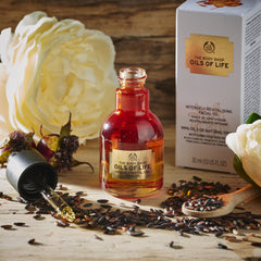 The Body Shop Oils of Life on cheek—silky finish for refreshed skin.