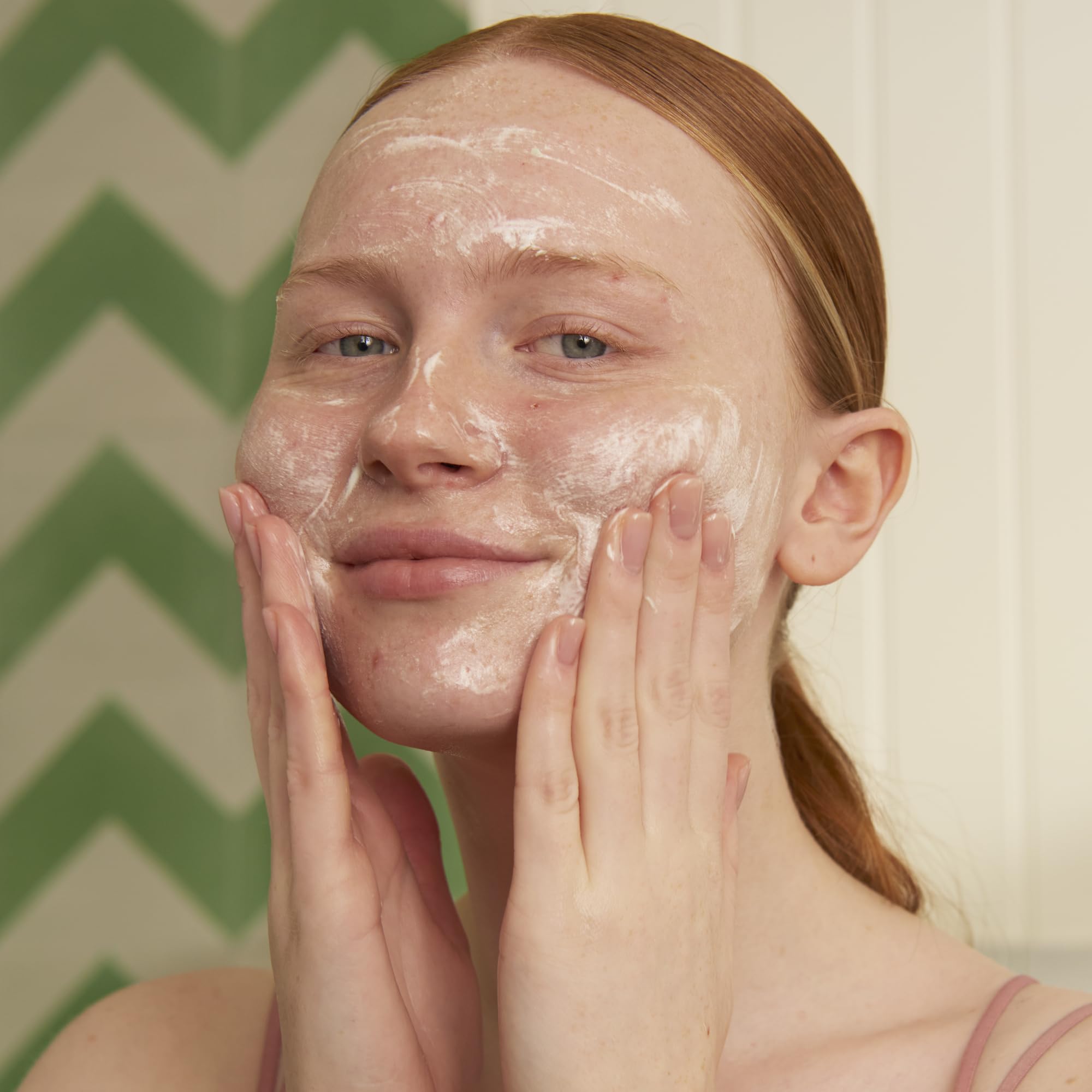 The Body Shop Tea Tree foaming cleanser foam close-up showing rich lather and clarifying action.