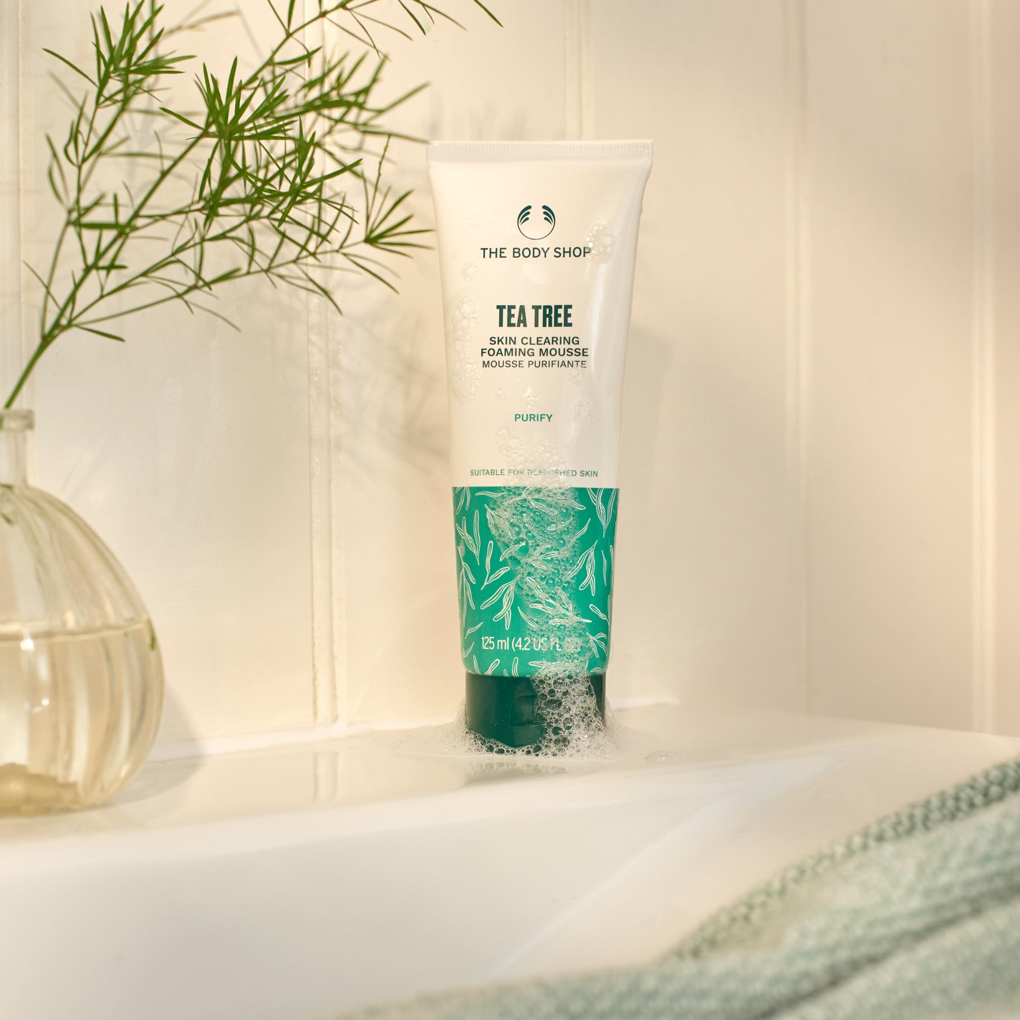 The Body Shop Tea Tree purifying cleanser face close-up highlighting clean, refreshed skin after washing.