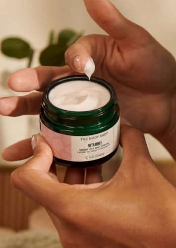 The Body Shop Vitamin E Moisture Cream on hand demonstrates quick absorption and non-greasy finish