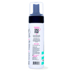 The Doux multi-use mousse curly-definition image emphasizes defined curls with natural movement.