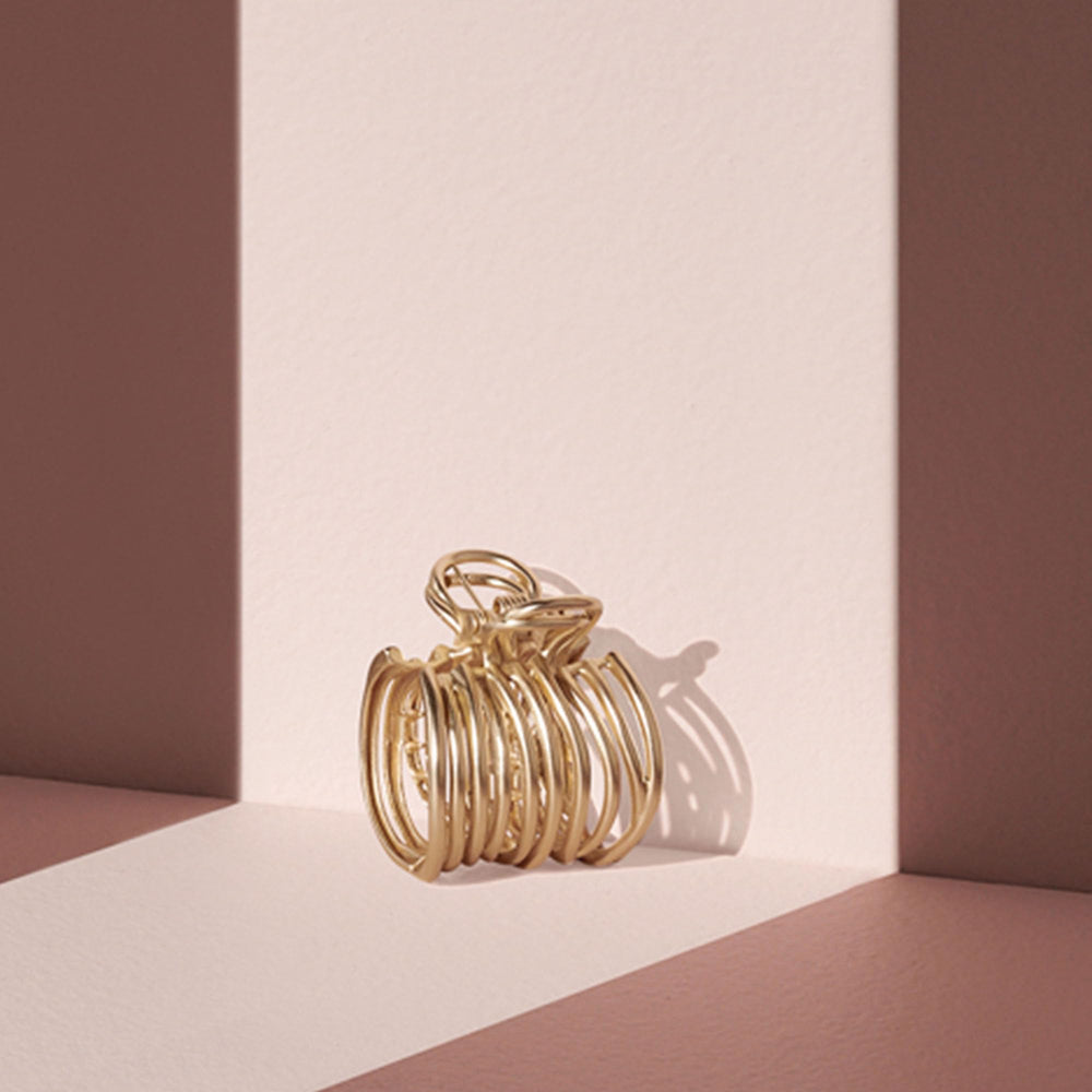 The Hair Edit gilded wrap ponytail cuff clip closeup gold finish adds luxe detail to any hairstyle.
