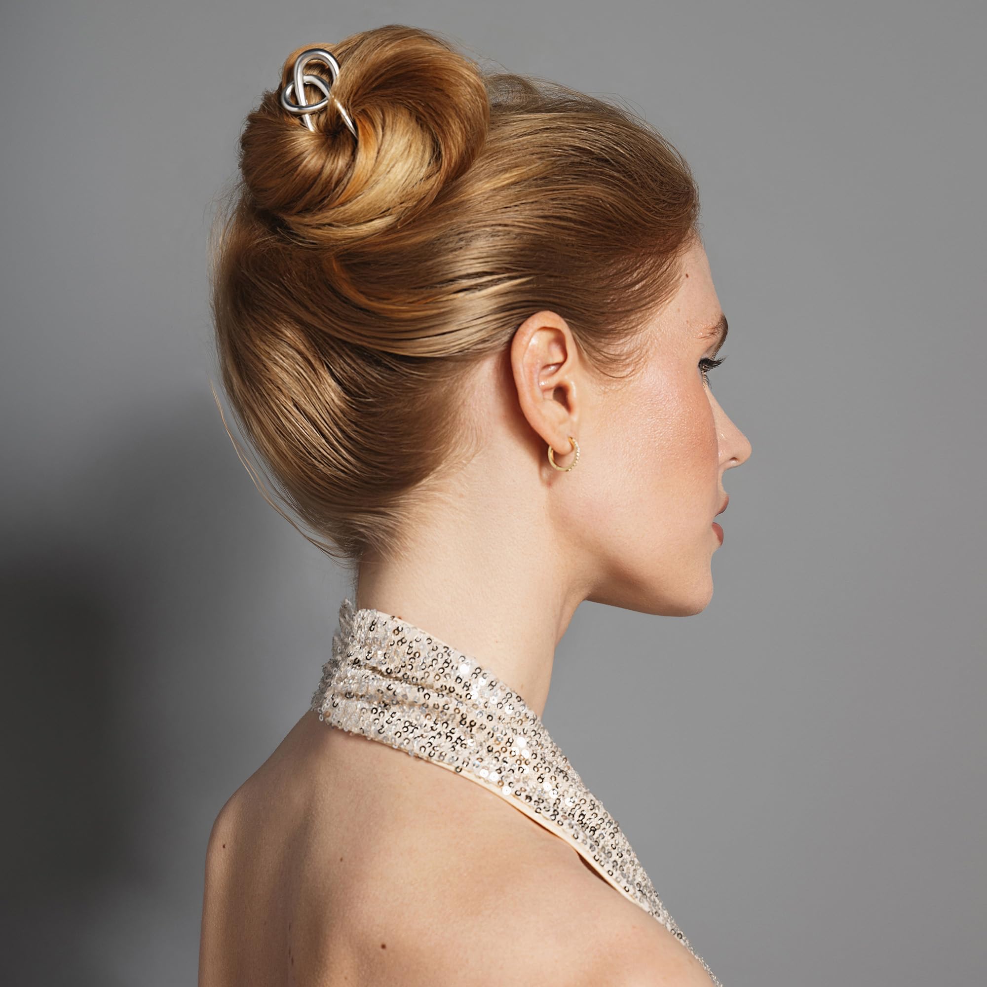 The Hair Edit knotted chignon pin closeup highlights smooth glide into hair for easy placement