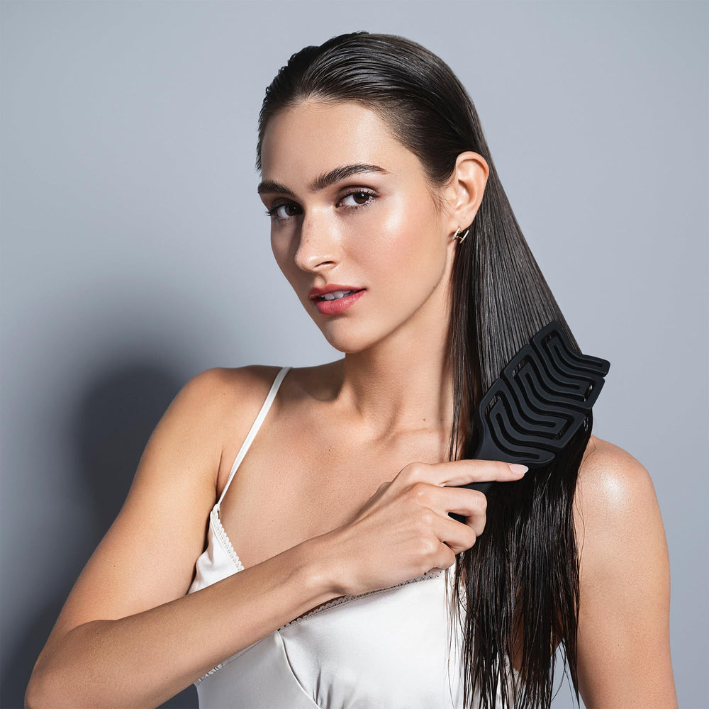 The Hair Edit scalp massage brush paddle offers a relaxing scalp stimulation during brushing.