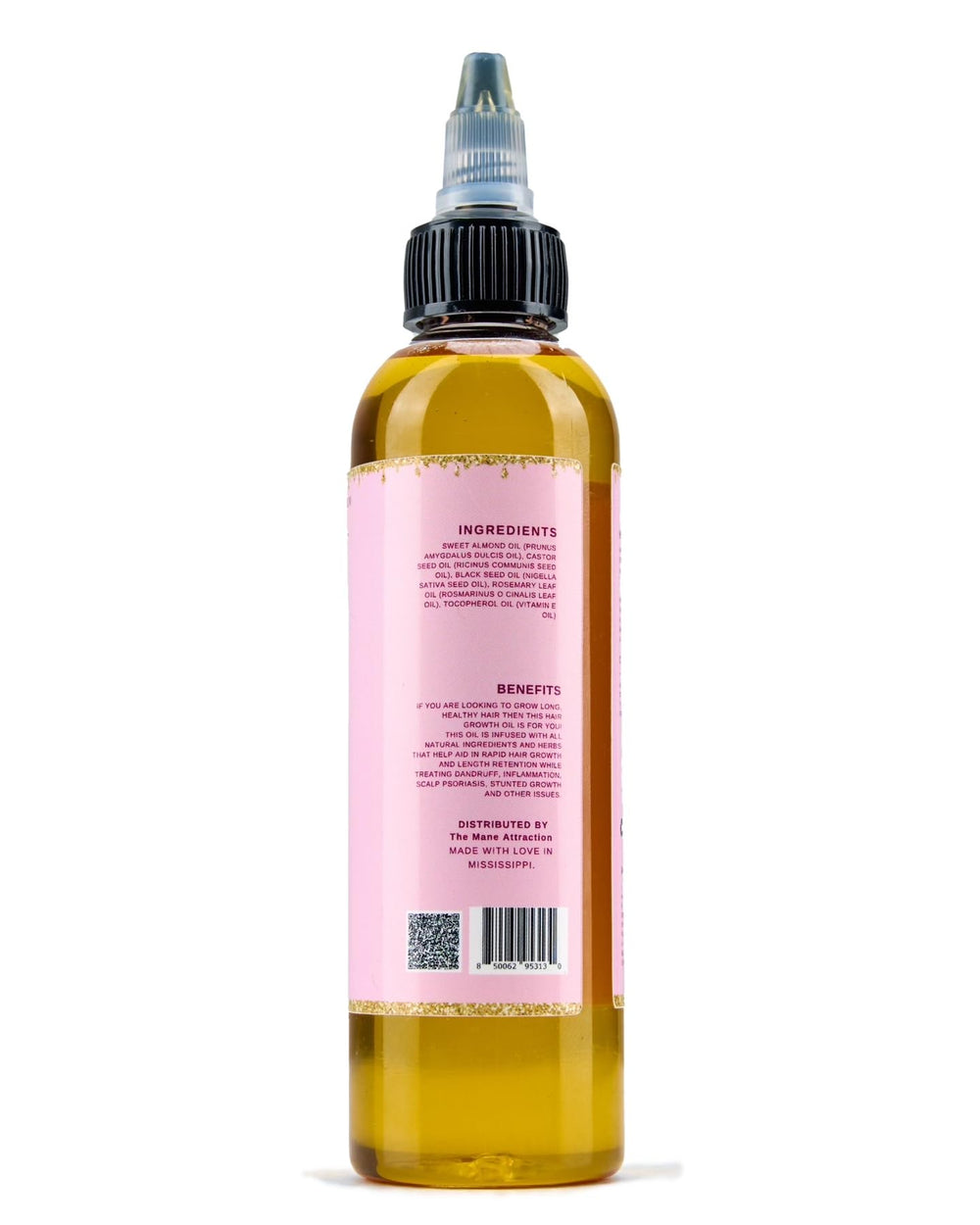 Premium packaging of The Mane Attraction hair oil on wood background