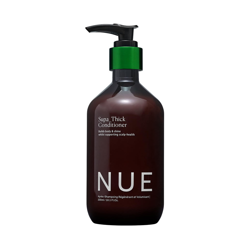 The Nue Co SUPA THICK Conditioner bottle closeup shows a hydrating formula for all hair types.