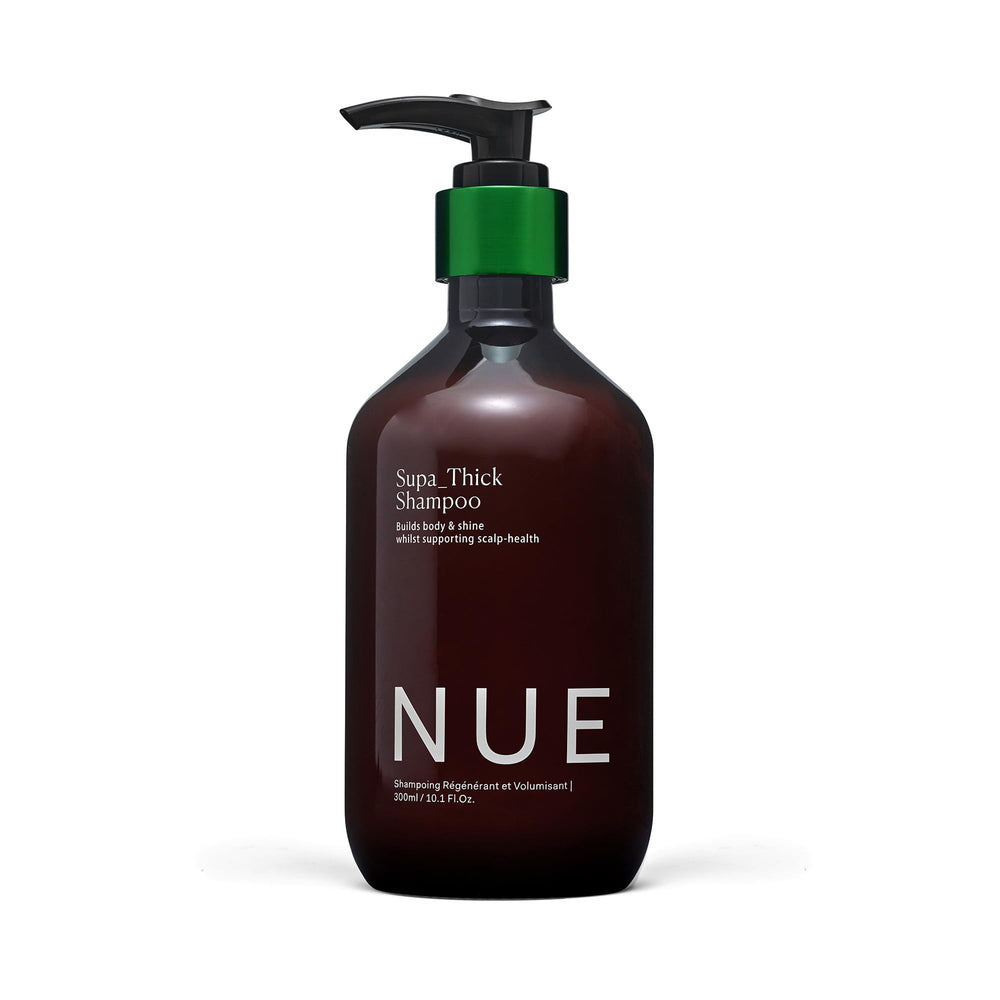 The Nue Co SUPA THICK Shampoo bottle front promotes balanced scalp and clean hair.
