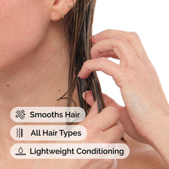 The Ordinary being worked into wet hair by hand, shows easy detangling and smooth application