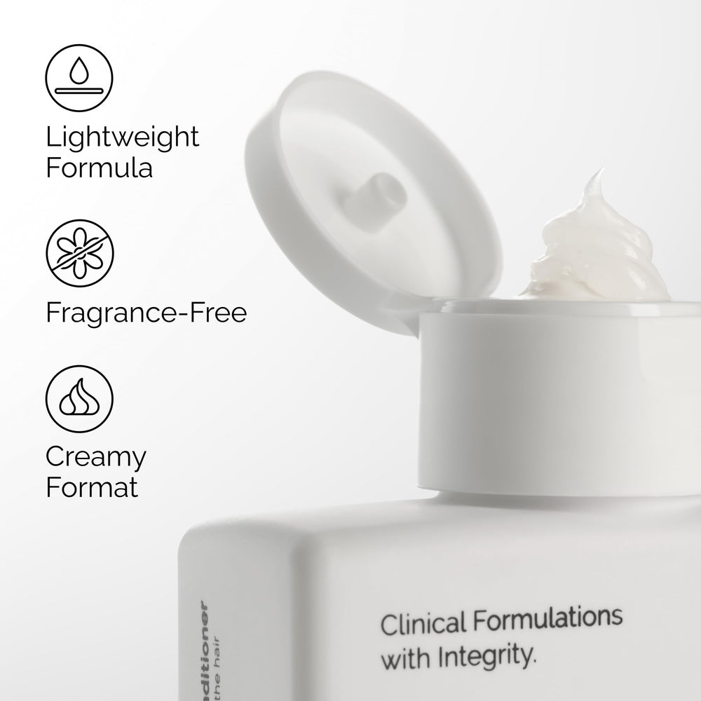 The Ordinary creamy conditioner texture on fingers, demonstrates lightweight slip and spreadability