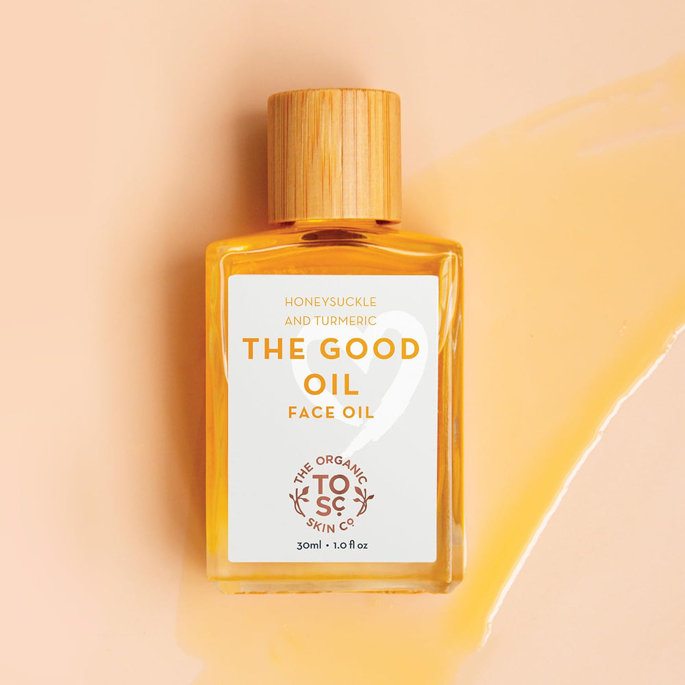 The Organic Skin Co Turmeric and CO2 extracted oil close-up emphasizes antioxidant-rich glow.