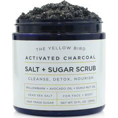 The Yellow Bird activated charcoal face scrub packaging highlights USA-made cleansing.
