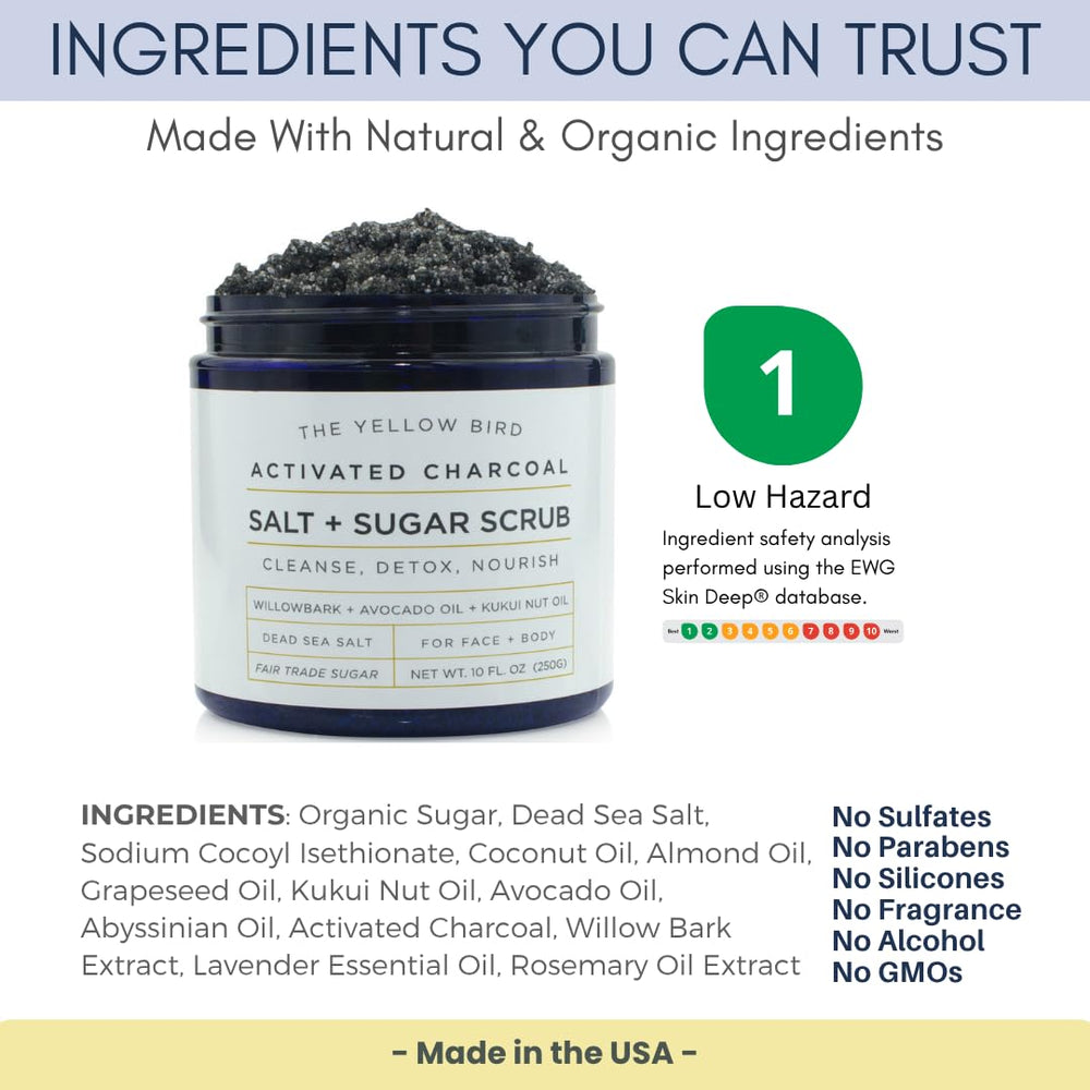 The Yellow Bird activated charcoal scrub salt sugar grains close-up demonstrates gentle exfoliation.