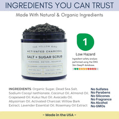 The Yellow Bird activated charcoal scrub salt sugar grains close-up demonstrates gentle exfoliation.