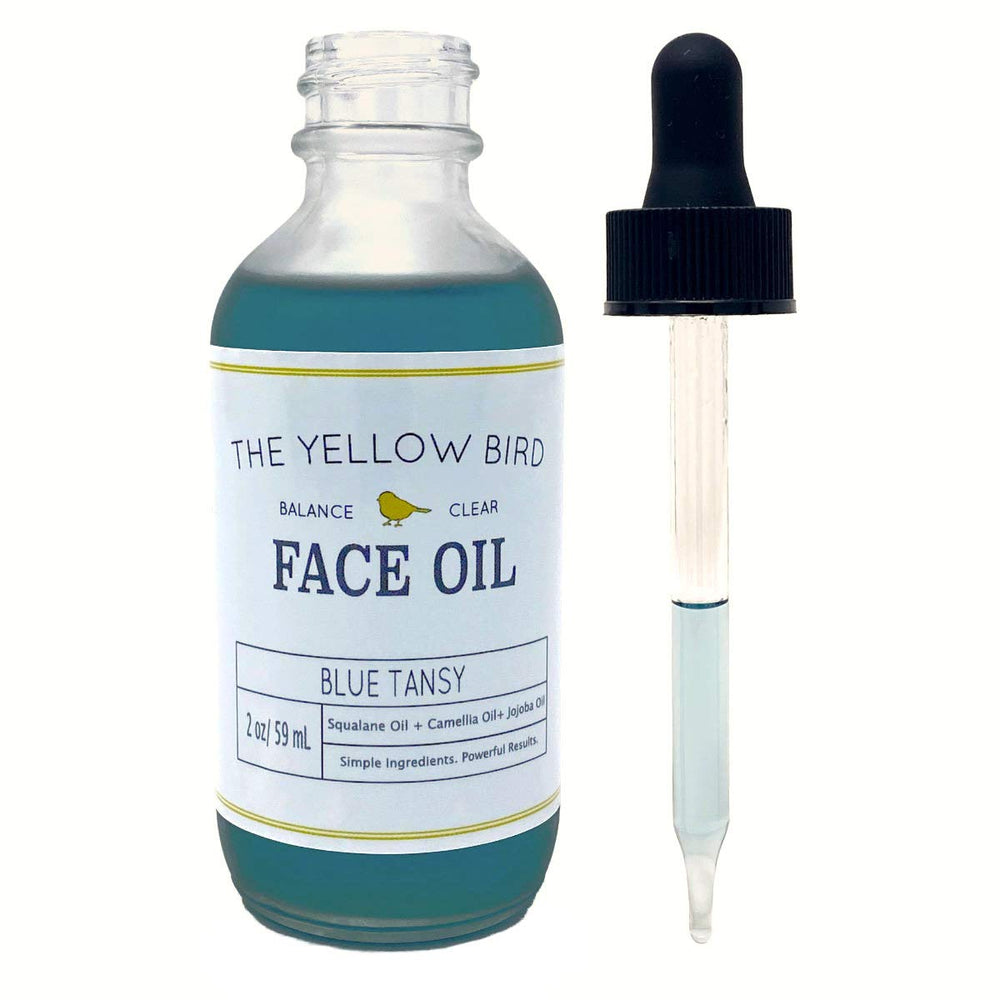 The Yellow Bird blue tansy bottle with calming botanicals for a soothing routine.