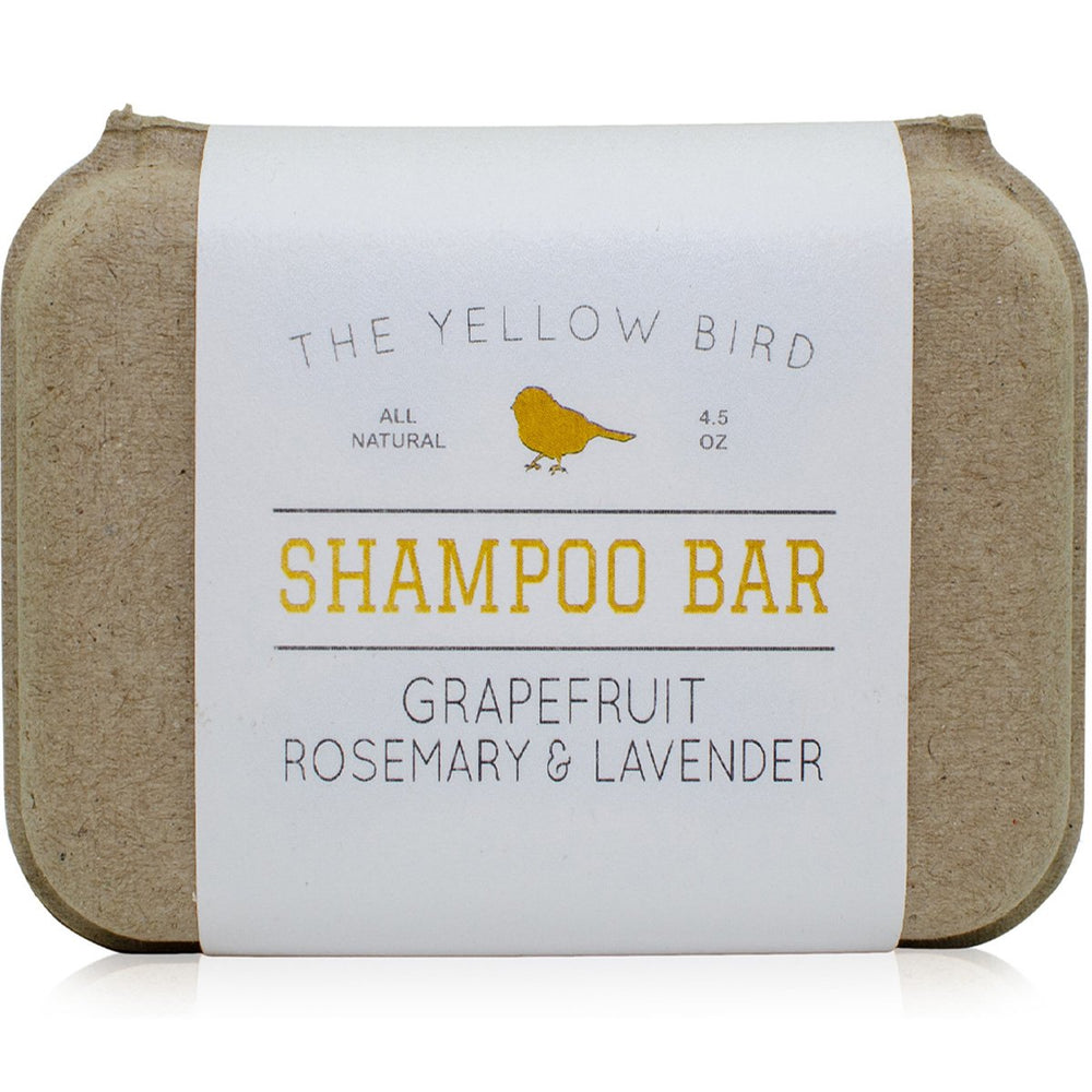 The Yellow Bird solid bar shampoo closeup shows grapefruit, rosemary and lavender aroma.
