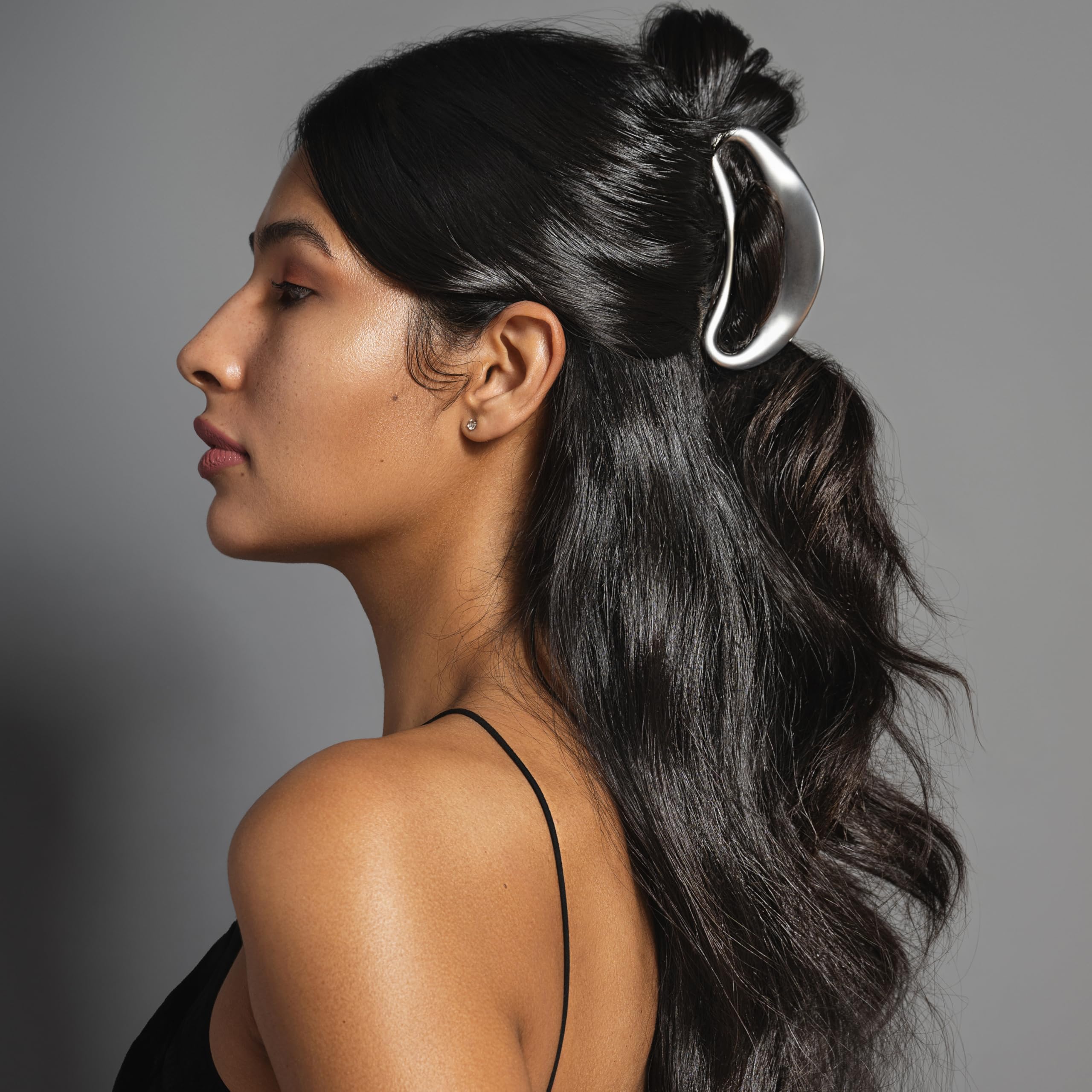 The Hair Edit Sculpted Silver Claw Clip in-use demonstrates easy up-do creation and secure hold.