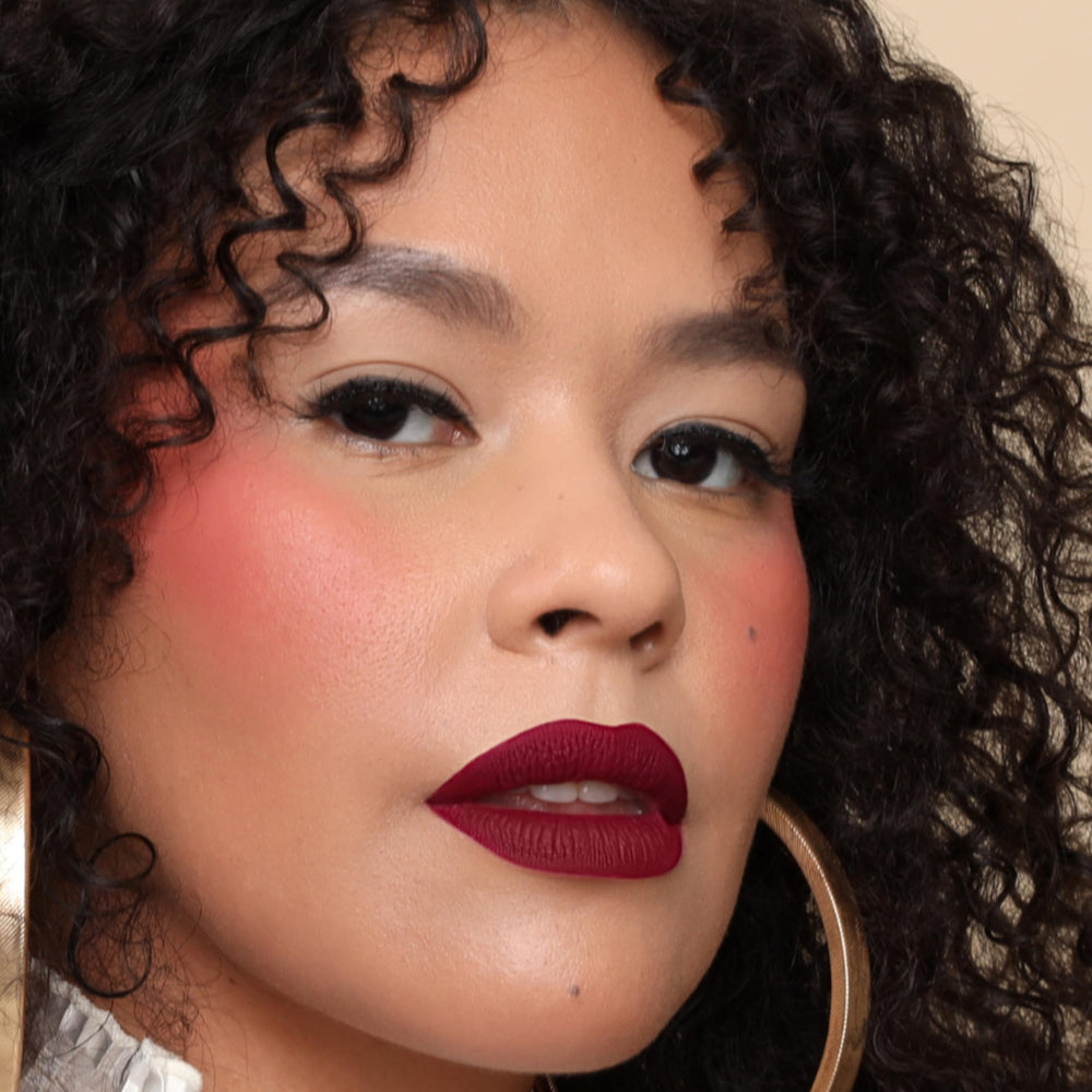 The Lip Bar Muse Deep Berry glam pout image suggests bold color for daily wear.