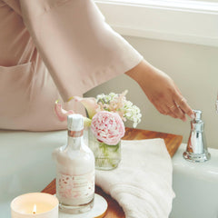 Thymes Bubble Bath Pour Under Warm Water demonstrates starting a relaxing bath ritual.