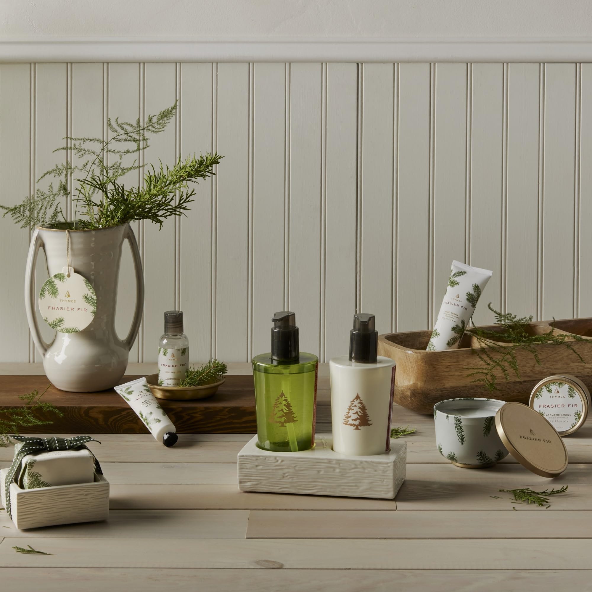 Thymes Frasier Fir holiday-table-decor scene suggests fragrance-enhanced ambiance.