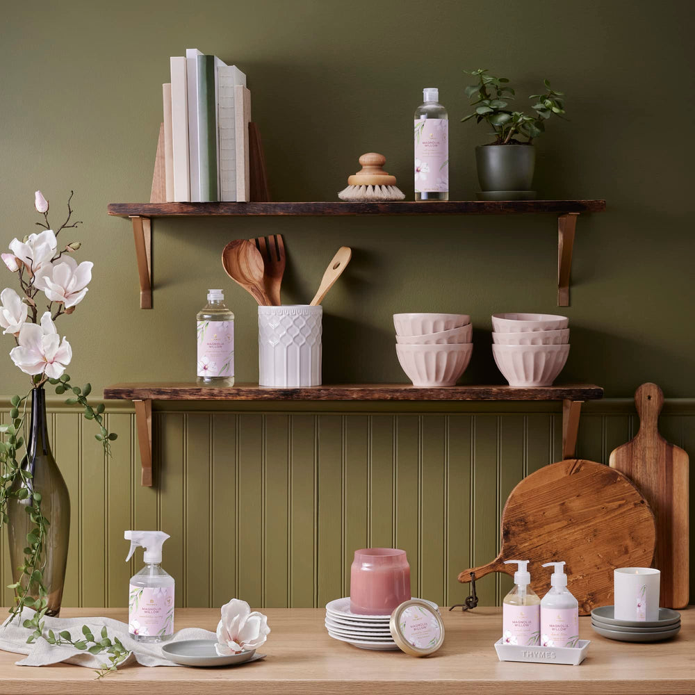 Thymes Magnolia Willow lotion in use shows quick, non-greasy absorption for moisturized hands.