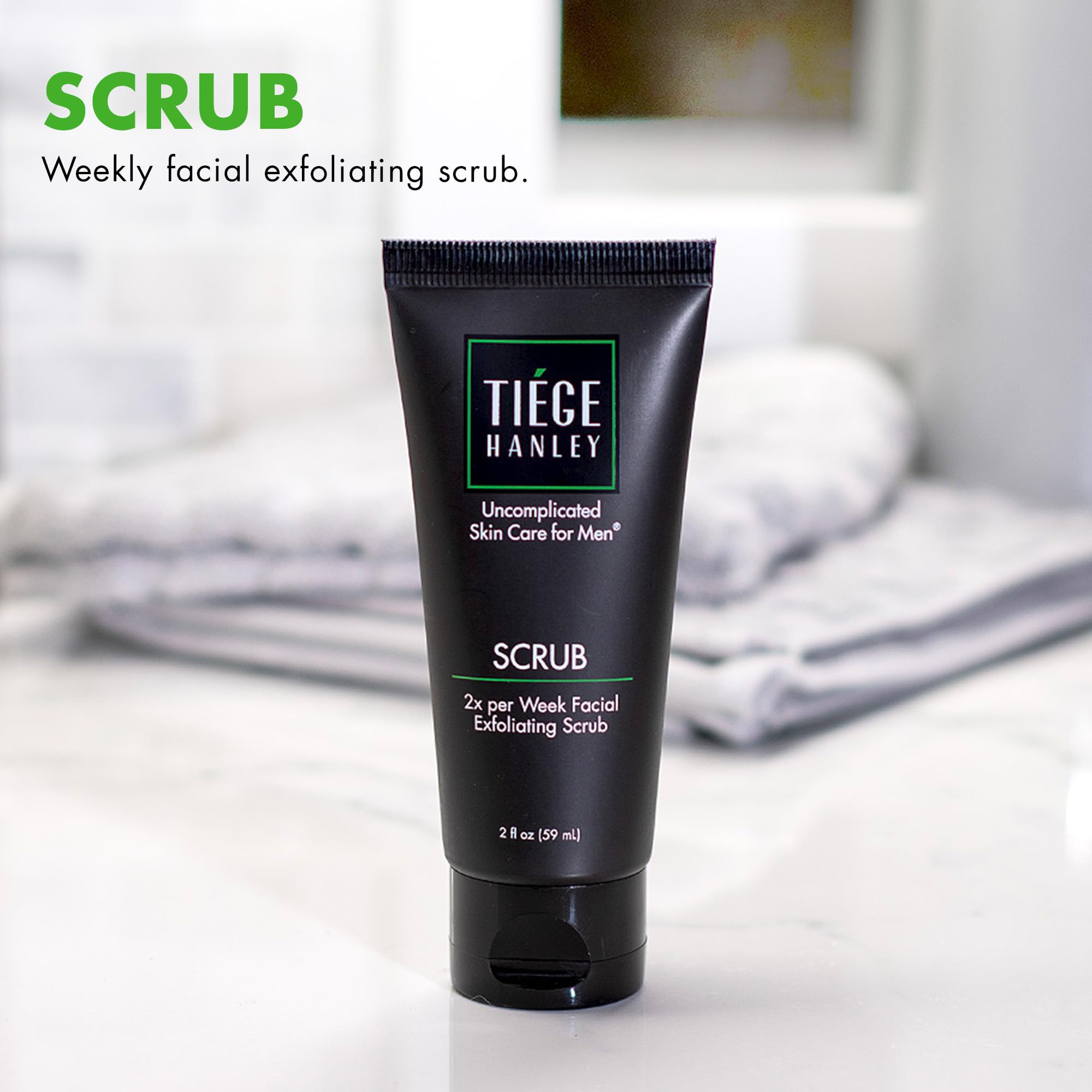 Tiege Hanley exfoliating face wash bottle close-up showing fragrance-free formula.