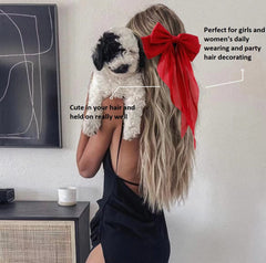 Tobeffect bow on long hair creating chic ponytail look.