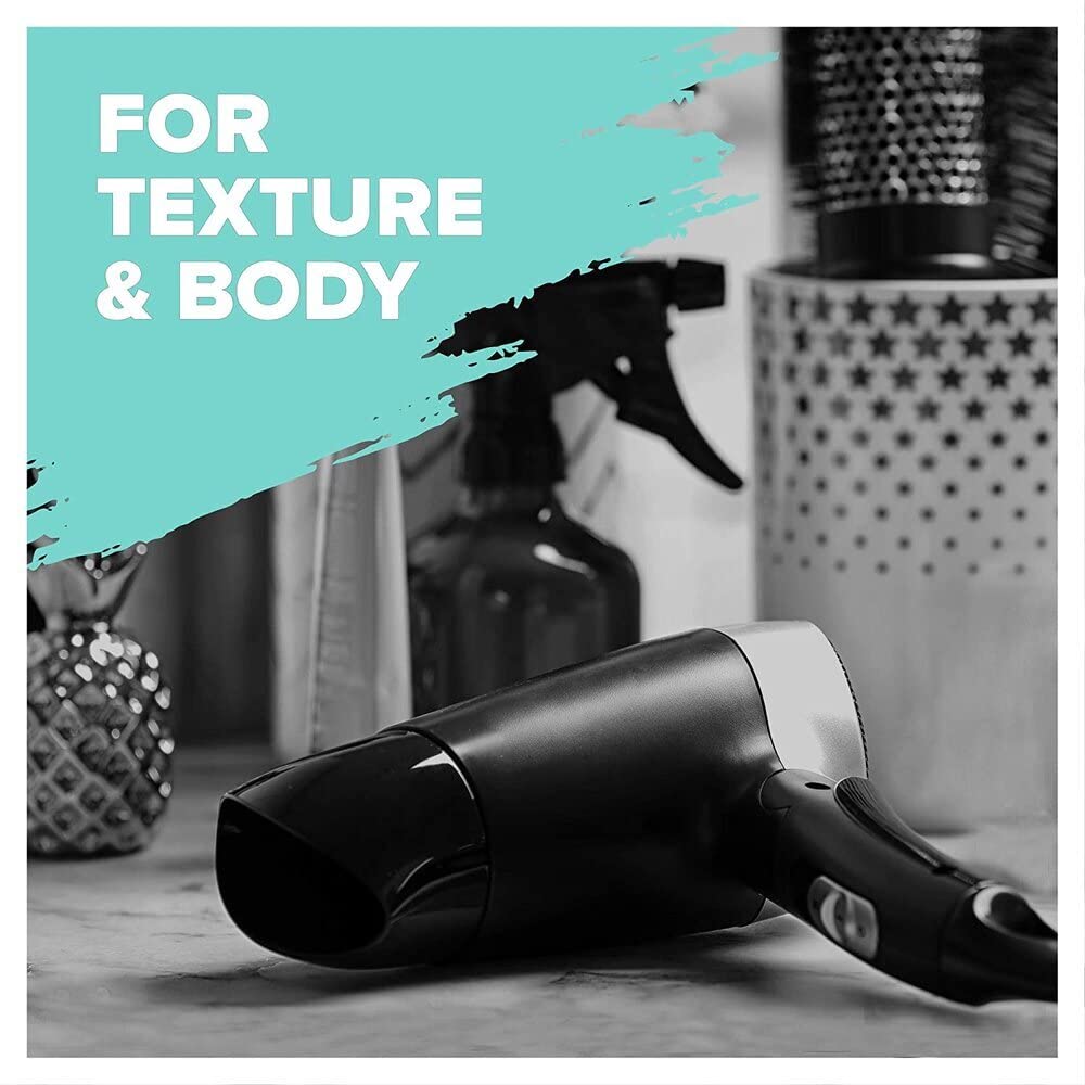 TONI&GUY Casual Sea Salt Spray applied to hair for natural movement.