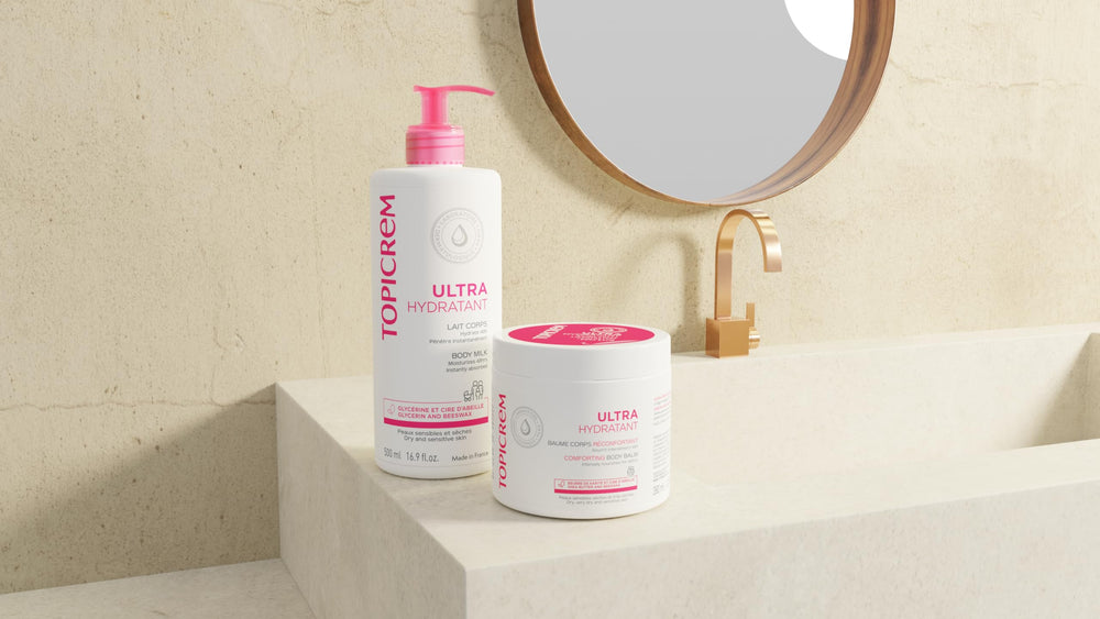 Topicrem Ultra-Moisturising Body Milk texture pour shot shows non-sticky formula.