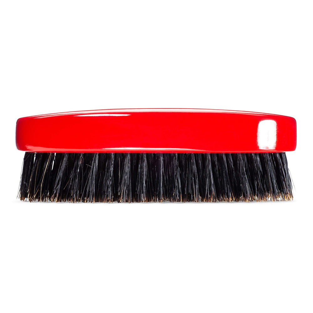 Torino Pro Wave Brush in hand demonstrates ergonomic oval shape and control