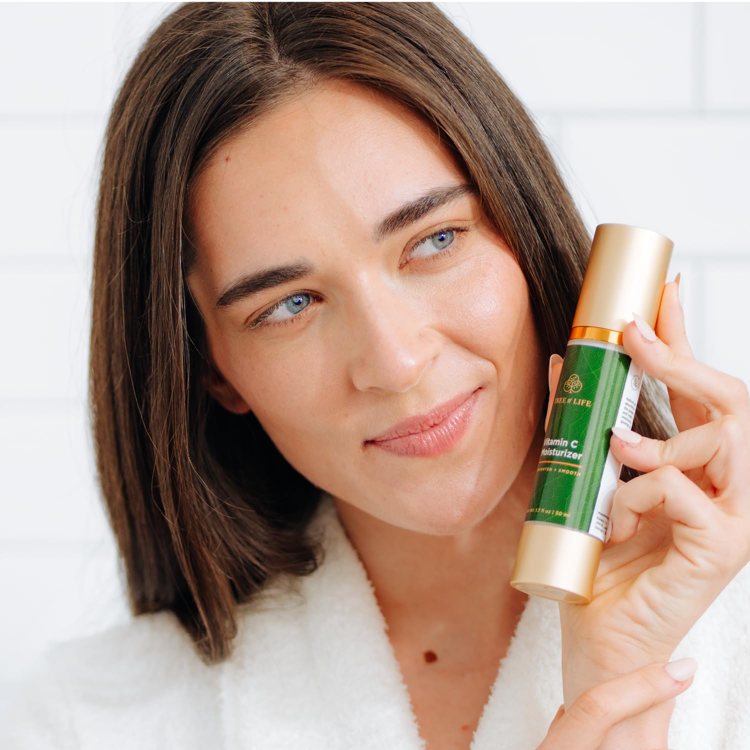 Tree of Life Beauty moisturizer being applied to the face for hydration.