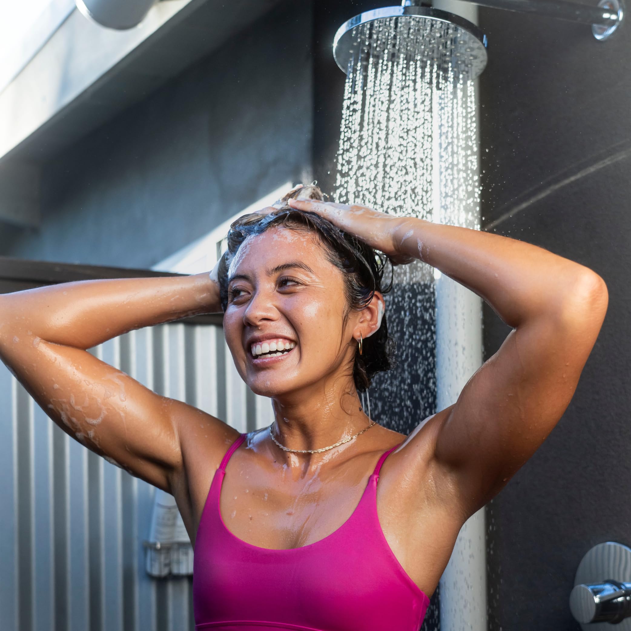 TRIHARD Swim Shampoo being applied to wet hair for post-swim cleansing.