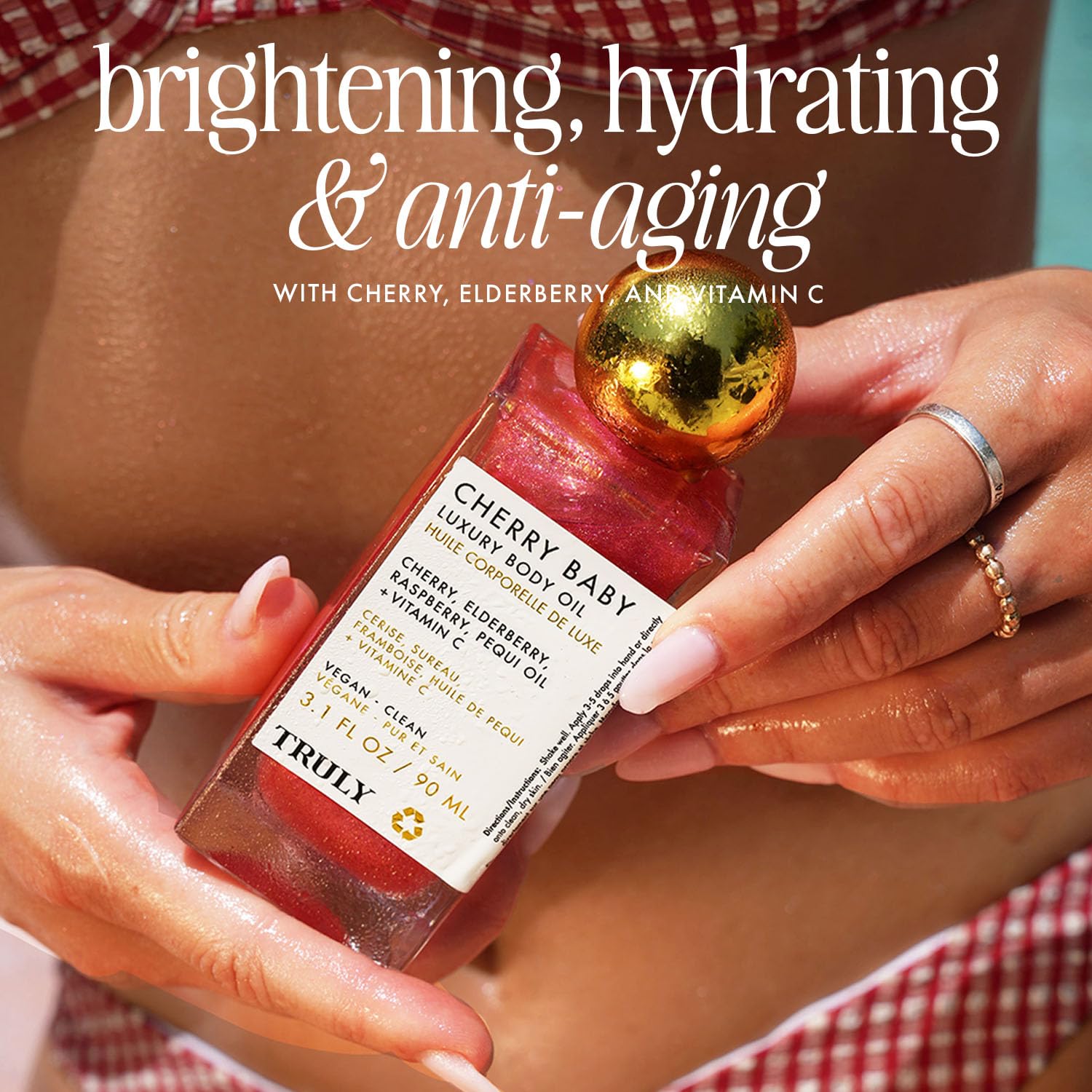 Truly Cherry Baby Oil beside cherries hints at antioxidant-rich formula.