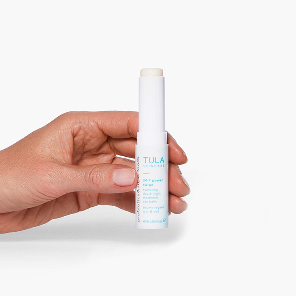 TULA 24-7 Power Swipe eye balm being applied under-eye demonstrates day-to-night use