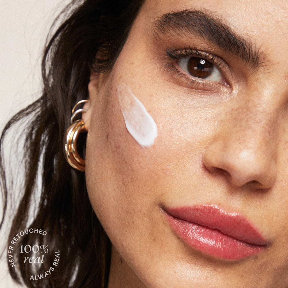 TULA chrome packaging reflection on mirror conveys premium, luxurious daily moisturizer.
