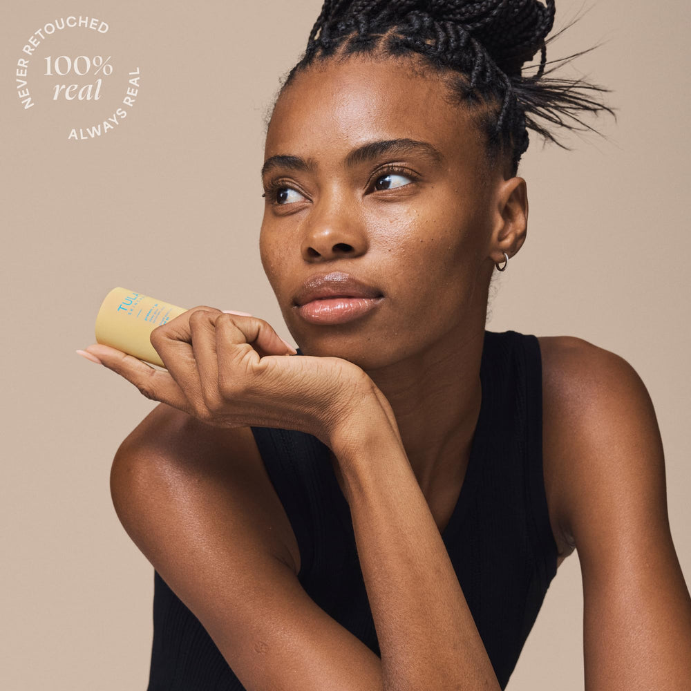 TULA Protect Glow applying sunscreen stick to cheek for easy coverage