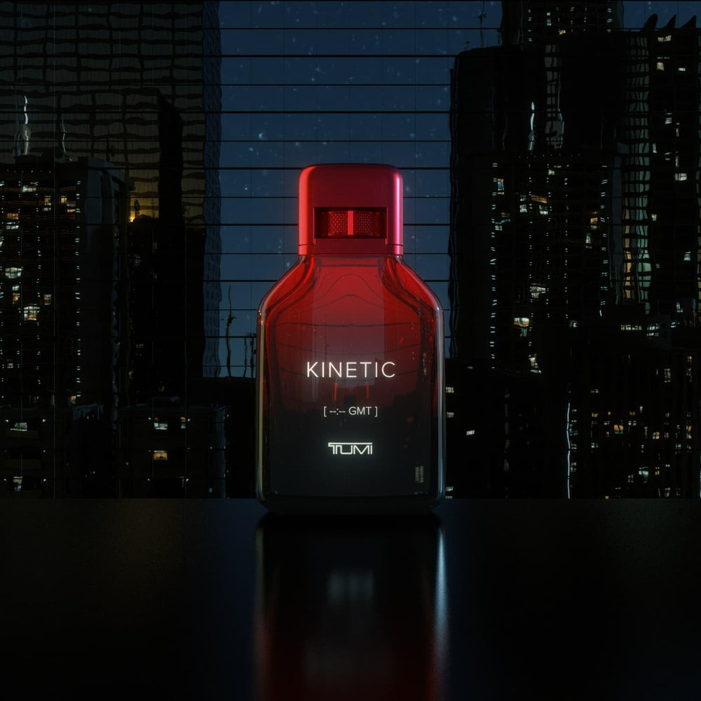 TUMI Kinetic for Men lifestyle setup on desk with bottle and notebook for professional wear.