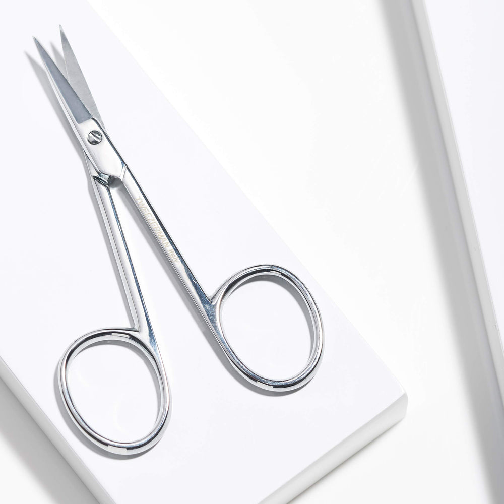 Tweezerman cuticle scissors cleaning and care image demonstrates quick wipe-down after use.